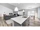 Open-concept kitchen and living area, with a bright kitchen island and stainless steel appliances at 11598 Platt St, Noblesville, IN 46060