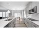 Modern kitchen showcasing gray cabinetry, stainless steel appliances, and an eat-in breakfast area at 11598 Platt St, Noblesville, IN 46060