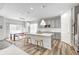 Bright kitchen with gray cabinets, white countertops, stainless steel appliances, and an island with seating at 11598 Platt St, Noblesville, IN 46060