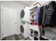 Bright laundry room featuring front loading machines, and organized shelving for storage and convenience at 11598 Platt St, Noblesville, IN 46060