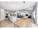 Open-concept kitchen and living area featuring stainless steel appliances, an island, and a modern fireplace at 11598 Platt St, Noblesville, IN 46060