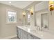 Stylish bathroom features a double vanity with granite countertops and modern fixtures at 1238 Alabama St, Indianapolis, IN 46202
