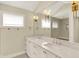 Bright bathroom featuring double sink vanity, marble countertops, and oversized mirror reflecting the shower at 1238 Alabama St, Indianapolis, IN 46202