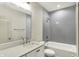Bathroom featuring gray subway tile, white vanity, and tub with shower at 1238 Alabama St, Indianapolis, IN 46202