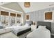 Bright bedroom with two twin beds, window seating, and patterned wallpaper at 1238 Alabama St, Indianapolis, IN 46202