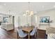 Well-lit dining room features hardwood floors, a modern chandelier, and seamless access to the kitchen and backyard at 1238 Alabama St, Indianapolis, IN 46202