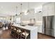 Open-concept kitchen with barstool seating, stainless appliances, and seamless integration into dining area at 1238 Alabama St, Indianapolis, IN 46202