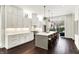 Modern white kitchen featuring a large island, stainless steel appliances, and hardwood floors at 1238 Alabama St, Indianapolis, IN 46202