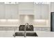 Stylish kitchen sink and fixtures complement the white marble countertops and cabinets at 1238 Alabama St, Indianapolis, IN 46202