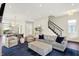 Spacious living room is open to the kitchen and has a staircase, hardwood floors, and neutral décor at 1238 Alabama St, Indianapolis, IN 46202