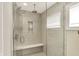 Modern walk-in shower with frameless glass door, white marble tile, built-in niche, and dual shower heads at 1238 Alabama St, Indianapolis, IN 46202