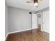 Bedroom with hardwood floors, neutral gray walls and trim, ceiling fan and doorways to other rooms at 1241 Brandt Dr, Indianapolis, IN 46241
