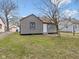 Charming home featuring gray siding, brown roof, and leafless tree in the front yard at 1241 Brandt Dr, Indianapolis, IN 46241