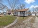 Quaint single-Gathering home with gray siding, brown roof, and detached garage at 1241 Brandt Dr, Indianapolis, IN 46241