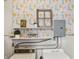 Functional laundry space with patterned wallpaper, shelving, washer and dryer hookups at 1241 Brandt Dr, Indianapolis, IN 46241