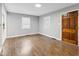 Hardwood floors and gray walls complement this living room with natural lighting from the windows at 1241 Brandt Dr, Indianapolis, IN 46241