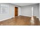 Spacious living room with hardwood floors, gray walls, a large window, and an arched doorway at 1241 Brandt Dr, Indianapolis, IN 46241