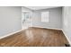 Living room featuring hardwood floors, gray walls, and window overlooking the backyard at 1241 Brandt Dr, Indianapolis, IN 46241