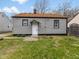 Home's rear facade with a simple yet appealing design and a well-kept lawn at 1241 Brandt Dr, Indianapolis, IN 46241