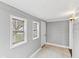 Cozy sunroom with gray painted walls, two windows, and white tiled flooring at 1241 Brandt Dr, Indianapolis, IN 46241