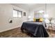 Bright bedroom featuring a bed with stylish pillows, wood-look floors, and modern light fixtures at 1252 Kappes St, Indianapolis, IN 46221