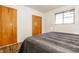 Cozy bedroom showcasing wood-look floors, a window, and a comfortable bed with a gray cover at 1252 Kappes St, Indianapolis, IN 46221