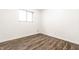 Bright, empty bedroom with wood-look floors and a window providing natural light at 1252 Kappes St, Indianapolis, IN 46221