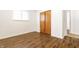 Spacious bedroom features wood-look floors, a closet, and an open doorway at 1252 Kappes St, Indianapolis, IN 46221