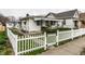 Quaint home with a white picket fence, covered porch, and well-maintained landscaping at 1252 Kappes St, Indianapolis, IN 46221
