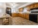 Traditional kitchen with wood cabinets, black appliances, and bright lighting at 1252 Kappes St, Indianapolis, IN 46221