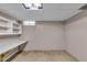 Finished portion of basement featuring shelves, desk area and glass block window at 1330 N Gibson Ave, Indianapolis, IN 46219