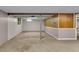 Unfinished basement with concrete floor, exposed support beams, and window at 1330 N Gibson Ave, Indianapolis, IN 46219
