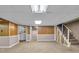 Unfinished basement featuring laundry area, storage, and stairs leading to the upper level at 1330 N Gibson Ave, Indianapolis, IN 46219