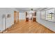 Inviting dining area featuring hardwood floors, a ceiling fan, and a large window for natural light at 1330 N Gibson Ave, Indianapolis, IN 46219