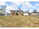 Single-story home with brick accents, attached garage, and a well-maintained lawn at 1330 N Gibson Ave, Indianapolis, IN 46219