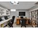 Functional home office with dual workspaces, ample shelving, and bright lighting, creating an efficient work environment at 1330 N Gibson Ave, Indianapolis, IN 46219