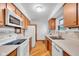 Functional kitchen with classic wooden cabinets, white appliances, and ample countertop space at 1330 N Gibson Ave, Indianapolis, IN 46219