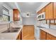 Open kitchen view with white appliances and wooden cabinets flowing into a dining space at 1330 N Gibson Ave, Indianapolis, IN 46219