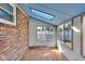 Bright sunroom featuring brick walls, light blue ceiling, and lots of windows at 1330 N Gibson Ave, Indianapolis, IN 46219