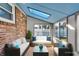 Inviting sunroom with skylight, brick accents, and comfortable seating, perfect for relaxation and enjoying natural light at 1330 N Gibson Ave, Indianapolis, IN 46219