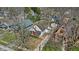 Aerial view showcasing the property surrounded by mature trees, neighboring homes, and a lush landscape at 136 W 43Rd St, Indianapolis, IN 46208