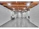 Clean basement with painted concrete floors and walls, exposed ceiling, and laundry hookups at 136 W 43Rd St, Indianapolis, IN 46208