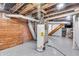 Basement utility area featuring hot water tank and brick and wood paneling at 136 W 43Rd St, Indianapolis, IN 46208