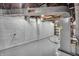 Utility area in basement with painted block walls, and exposed ductwork and pipes at 136 W 43Rd St, Indianapolis, IN 46208
