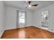 Cozy bedroom with hardwood floors, a ceiling fan, and an attached bathroom at 136 W 43Rd St, Indianapolis, IN 46208