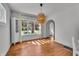 Bright dining room featuring hardwood floors, a large window, and a stylish pendant light fixture at 136 W 43Rd St, Indianapolis, IN 46208