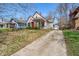 Attractive home with a vibrant red door, manicured shrubs, and a long driveway at 136 W 43Rd St, Indianapolis, IN 46208
