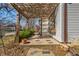 Charming front porch with a wooden pergola and stone-laid walkway leading to the entrance at 136 W 43Rd St, Indianapolis, IN 46208