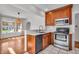 Open concept kitchen with wood cabinets, stainless steel appliances and view to dining area at 136 W 43Rd St, Indianapolis, IN 46208