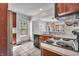 Charming kitchen with stainless steel appliances, a view of the dining area, and tile floor at 136 W 43Rd St, Indianapolis, IN 46208